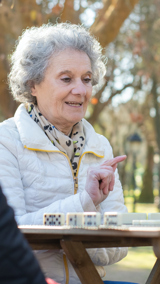 Sagora | senior woman playing a game outisde