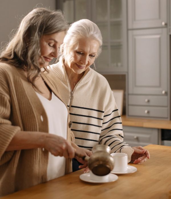 Sagora | Two senior women preparing coffee in a kitchen